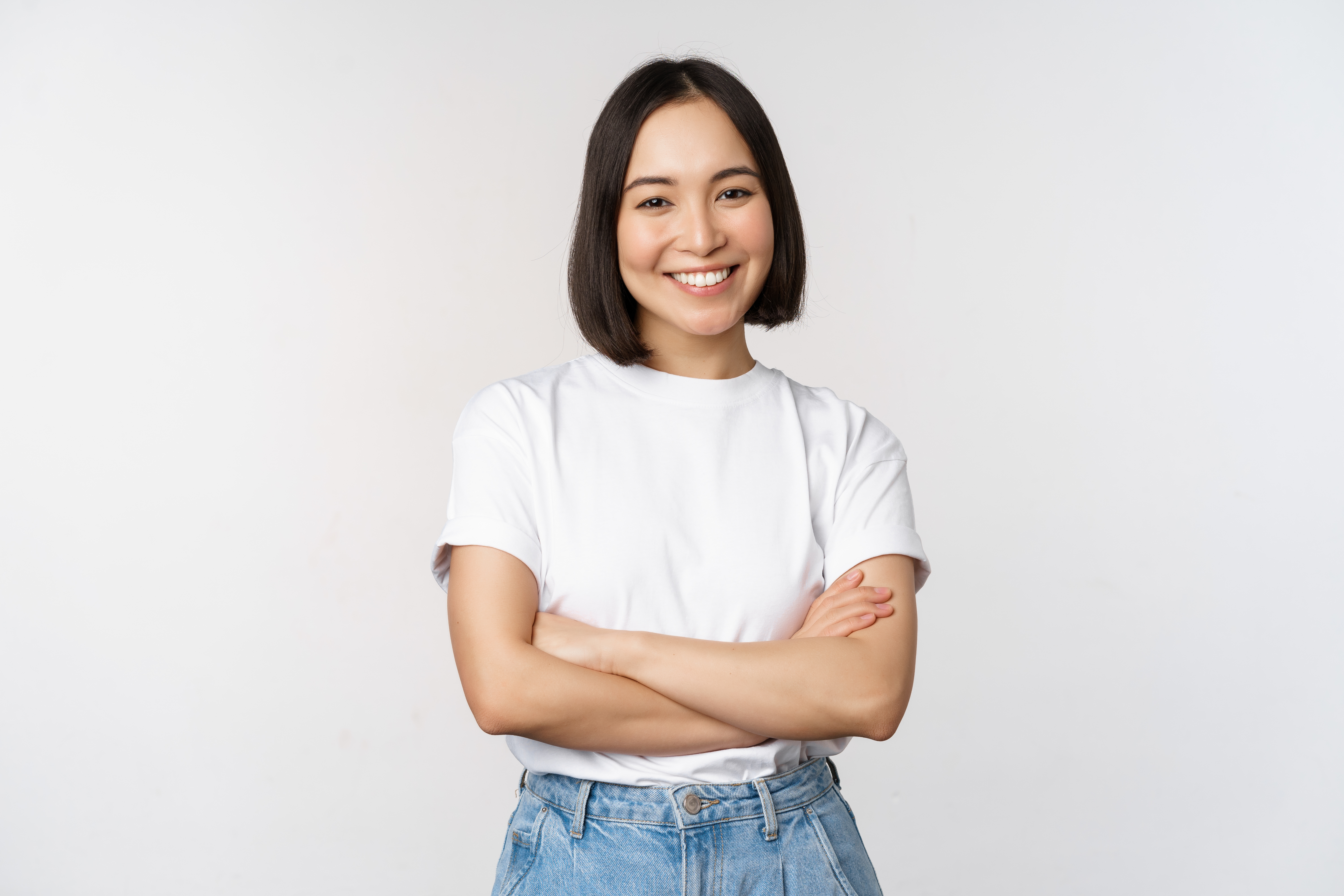 portrait-happy-asian-woman-smiling-posing-confident-cross-arms-chest-standing-against-studio-background
